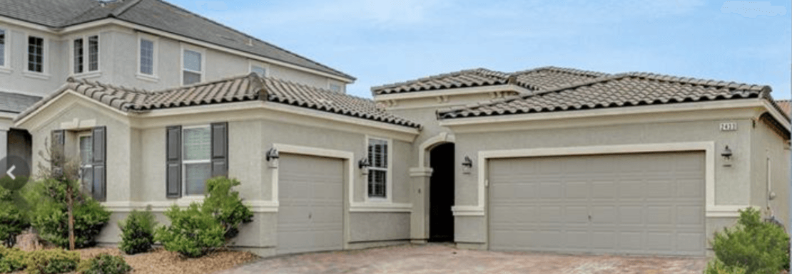 Single-story exterior with two-car garage and tile roof at 2433 Amatrice Street in Inspirada, Henderson NV